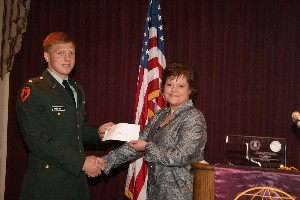 Taylor (r) presents an ROTC scholarship to Timothy Hebert, Army ROTC, Oklahoma State University, at the April chapter meeting.